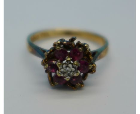 A 9ct gold, red stone and diamond ring, 2.4g, K