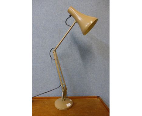 A beige metal anglepoise desk lamp 
