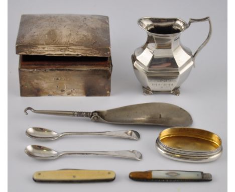 A silver cream jug, oval panelled form with scroll handle on four shell feet, London 1902, together with a silver cigarette b