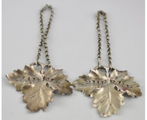 A pair of George III silver vine leaf decanter labels, Madeira and Sherry, Benjamin Smith 1817. H. 6cm