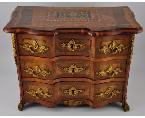 An Italian marquetry inlaid birdseye maple and walnut miniature commode, fitted 3 gilt metal mantel drawers, W. 42cm