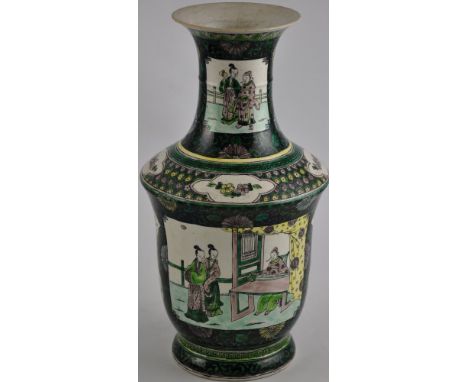 A late 19th century Chinese Famille Noire porcelain vase of shaped cylindrical form with flared neck decorated with panels of