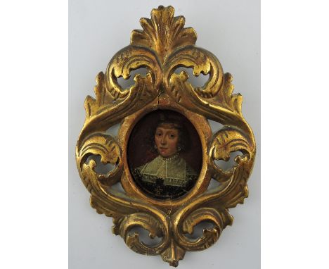 A 17th/18th Century oval miniature portrait on copper depicting a lady with crucifix brooch in carved giltwood Floretine styl