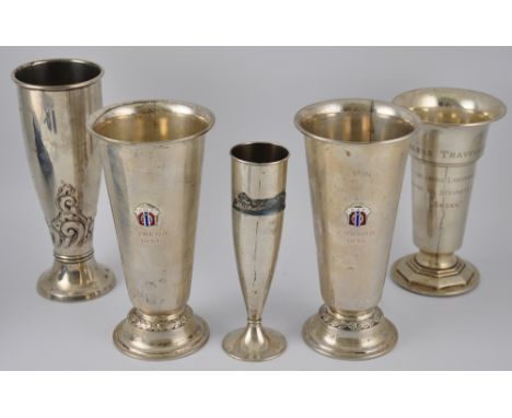 A pair of Continental white metal trophy goblets, tapering cylindrical form on raised circular bases, with applied enamel cre