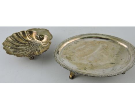 A silver shell shaped bon bon dish on three ball feet, Birmingham 1907, and an oval teapot stand 