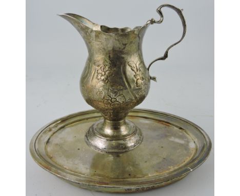 A George III silver pyriform florally chased sides, double scroll handle on raised circular base, London 1773, together with 