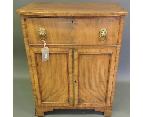 A George IV boxwood strung narrow mahogany side cabinet with bowed top over a deep frieze drawer with lion mask ring handles 