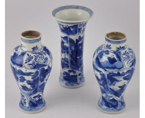 A Chinese late 17th/early 18th century Kangxi period three piece blue and white garniture set of baluster vases and a flared 