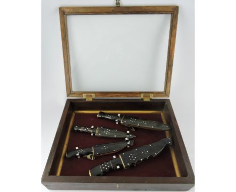 A collection of four 20th Century horn handled steel hunting knives with horn scabbards, all with metal stud decoration conta