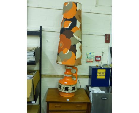 A 1970's West German pottery table lamp decorated in orange and cream glazes below a matching conical fabric shade, h. inc. s