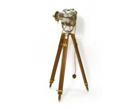 A Strand Electric polished chrome theatre spotlight on a mahogany and brass tripod base CONDITION REPORT: Re-wired, working o