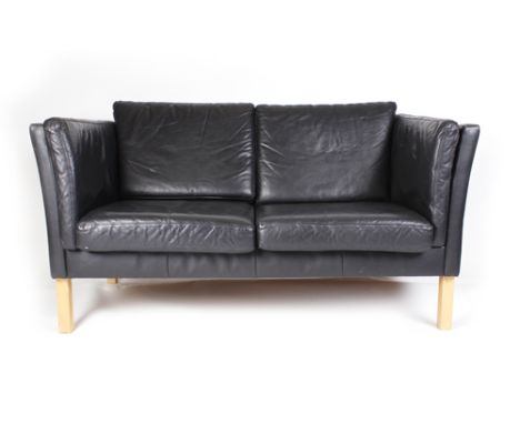 A black leather London-style two seater sofa on square beech legs, w. 140 cm