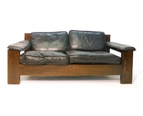 A 1970/80's two seater sofa, the black leather upholstery on a stained beech frame of angular form, by Leolux CONDITION REPOR