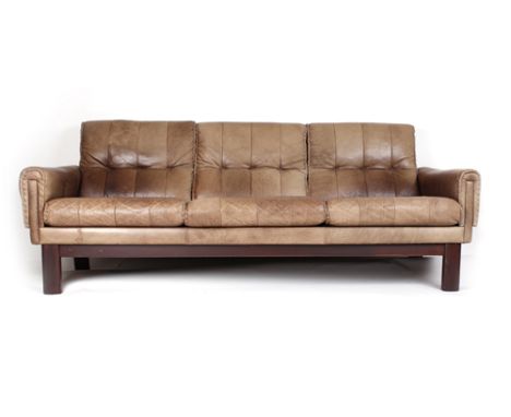 A brown buttoned leather three seater sofa having stitched decoration on square feet, l. 207 cm