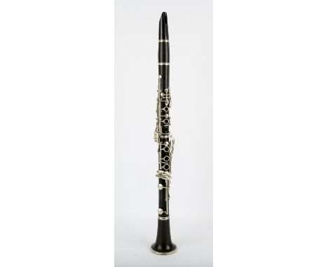 A Cousenon clarinet in case, blackwood and black bakelite, one stem section impressed 'Cousenon S.A Paris', with two mouth pi