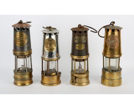 An early 20th century miners lamp by J.H. Naylor Ltd Wigan, another by Hailwood and Ackroyd Ltd and two further, similar lamp