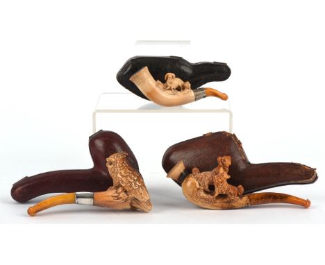 A late 19th century Meerschaum pipe, the bowl carved as an owl with silver collar and amber mouth piece, length 10.5cm, cased