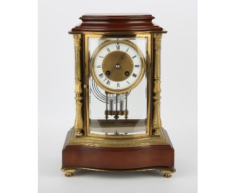 An early 20th century French four glass mantel clock of shaped form, the enamelled dial with Roman numerals enclosing a two t