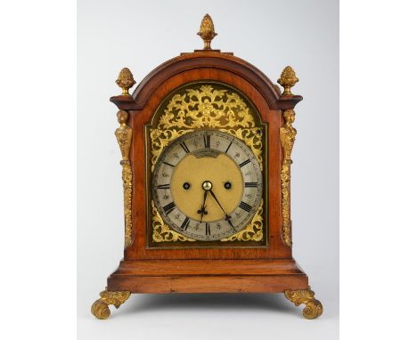 A late Victorian rosewood cased mantel clock, the 12cm dial with a steel chapter ring, the domed case with gilt brass finials