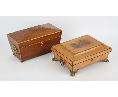 George III low sarcophagus workbox, with gilt metal ring handles and paw feet, the interior with the remains of a paper inter