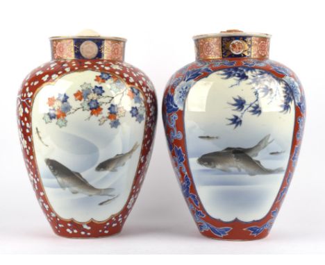 An associated pair of Fukagawa Imari vases; each one decorated with typical panels of swimming carp and natural science desig