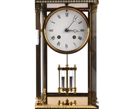 A Victorian style brass mantel clock, the 4 inch white enamel dial with Roman numerals, the glazed sides with Corinthian colu