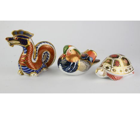 Royal Crown Derby, a Dragon paperweight with gold button, boxed, a Mandarin Duck paperweight with silver button, boxed and a 