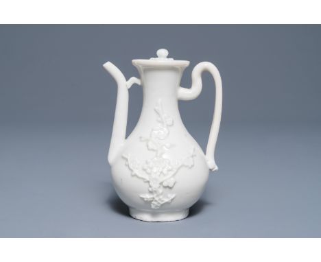 A Chinese Dehua blanc de Chine wine jug and cover with applied floral design, Kangxi     H.: 11,5 cm  Provenance: - The colle
