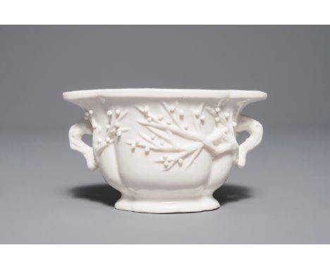A Chinese quatrefoil blanc de Chine two-handled wine cup, Kangxi     Dim.: 12 x 8,5 x 7 cm         Condition reports and high