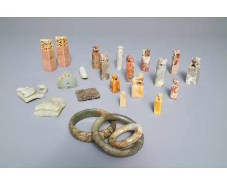 A collection of 23 Chinese jade, soapstone and hardstone seals, carvings, hooks and bangles, 19/20th C.     H.: 10 cm (the ta