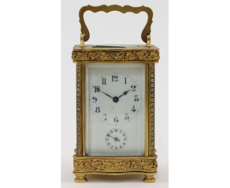 A French gilt-brass and glass panelled carriage clock, 20th century, the serpentine front and back case with swing handle and