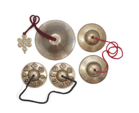 Two pairs of Tibetan bronze cymbals and a hanging bell, tingsha, 19th - 20th century, comprising: a pair of 19th century cymb