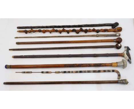 A collection of walking sticks, 19th - 20th centuries, to include an Indian white metal handled stick with repousse decoratio