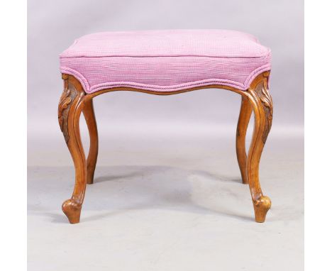 A Victorian walnut stool, in the French taste, third quarter 19th century, on carved cabriole legs, 43cm high, 52cm wide, 52c