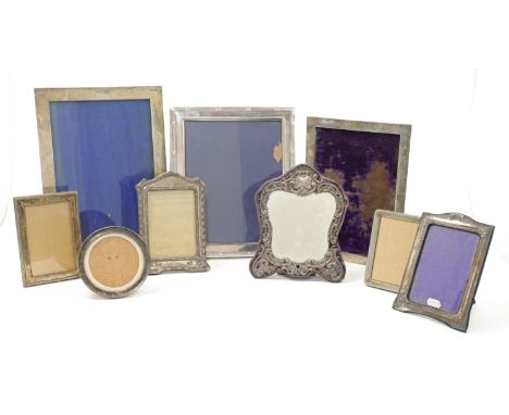 An Edwardian silver mounted dressing table mirror, Birmingham, 1905, Henry Matthews, of shaped form, repousse decorated with 