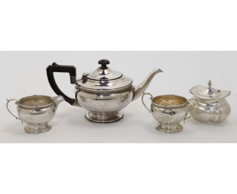 A three-piece silver tea set, comprising: a tea pot, a cream jug and a twin handled sugar bowl, Birmingham, 1946, Ernest W Ha