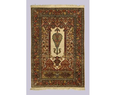 A Persian part silk Qum rug, last quarter 20th century, the central field with large central plant and hanging lantern beneat