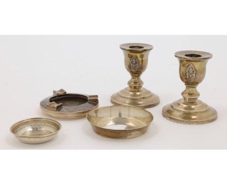 A pair of white metal candlesticks, a nielloed composite ashtray and a small white metal dish, Thailand, and Turkey, 20th cen