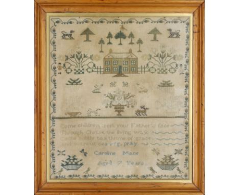 A Victorian needlework sampler by Caroline Mace, aged 7 years, depicting a landscape with a country house, flowering vases, a