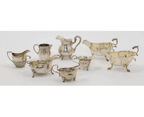 A group of sauce boats and cream jugs, comprising: an Edwardian silver sauce boat, Birmingham, 1908, Williams (Birmingham) Lt
