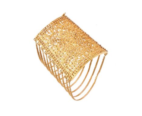 An Indian cuff bracelet of filigree design, the curved trapezium panel with openwork filigree construction, embellished with 