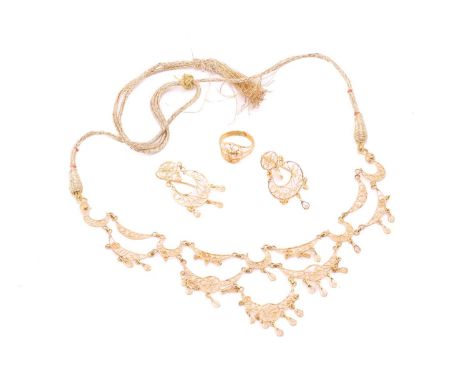 A filigree suite comprising a necklace, a pair of earrings and a ring; the necklace of festoon form, with crescent motifs and
