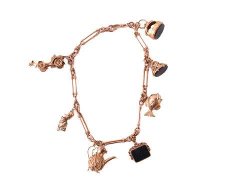 A 9ct rose gold watch chain with charms, comprising a trombone link chain terminated with a swivel clasp, suspending with a c