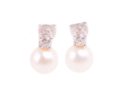 A pair of cultured pearl and diamond earrings in 18ct white gold, each comprising an 8.0 mm white coloured round pearl with s