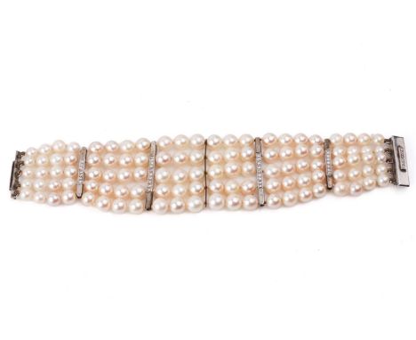 A five-row graduated pearl bracelet with diamond-set spacers, comprising one hundred and ten cultured pearls with cream body 