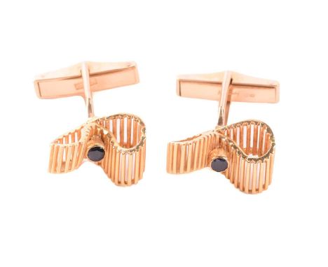 Kutchinsky - a pair of 18ct yellow gold cufflinks set with sapphires, of undulating ribbon design, each collet-set with a cir