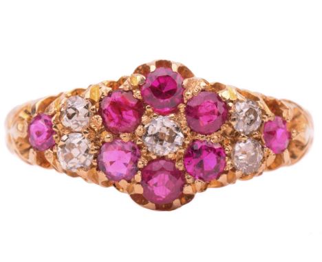 An Edwardian ruby and diamond cluster ring, circa 1912, the daisy cluster design with further diamonds and rubies extending a