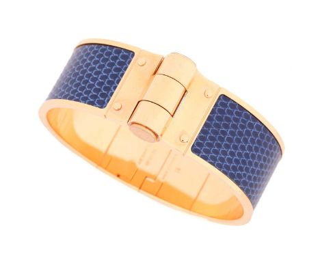 Hermès - a Charnière cuff bracelet, a wide hinged bangle in yellow-tone hardware, inlaid with navy blue lizard leather, with 
