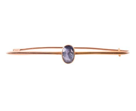 A sapphire-set bar brooch, collet-set with an oval-cut sapphire of pale greyish-blue colour, approximately measures 10.3 x 6.