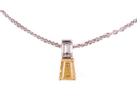 A yellow diamond pendant on an 18ct gold chain, claw-set with a tapered baguette-cut yellow diamond of 1.03ct, with an emeral